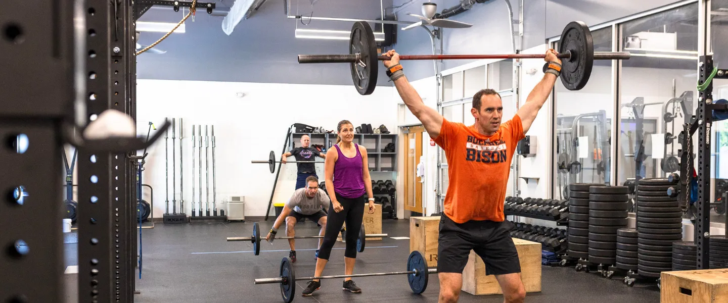 A man lifts a weight during a Westridge CrossFit session.