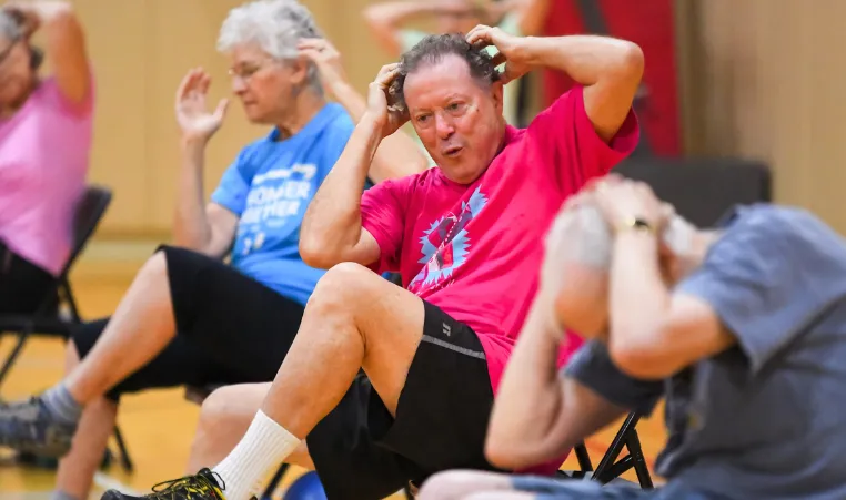 A group of people exercise during a group exercise class.
